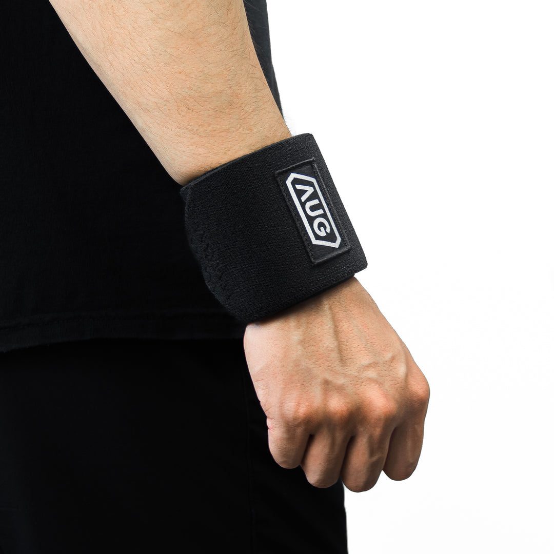 Athlete wearing wrist wraps for heavy press for grip stability and wrist injury prevention for powerlifting competitions.