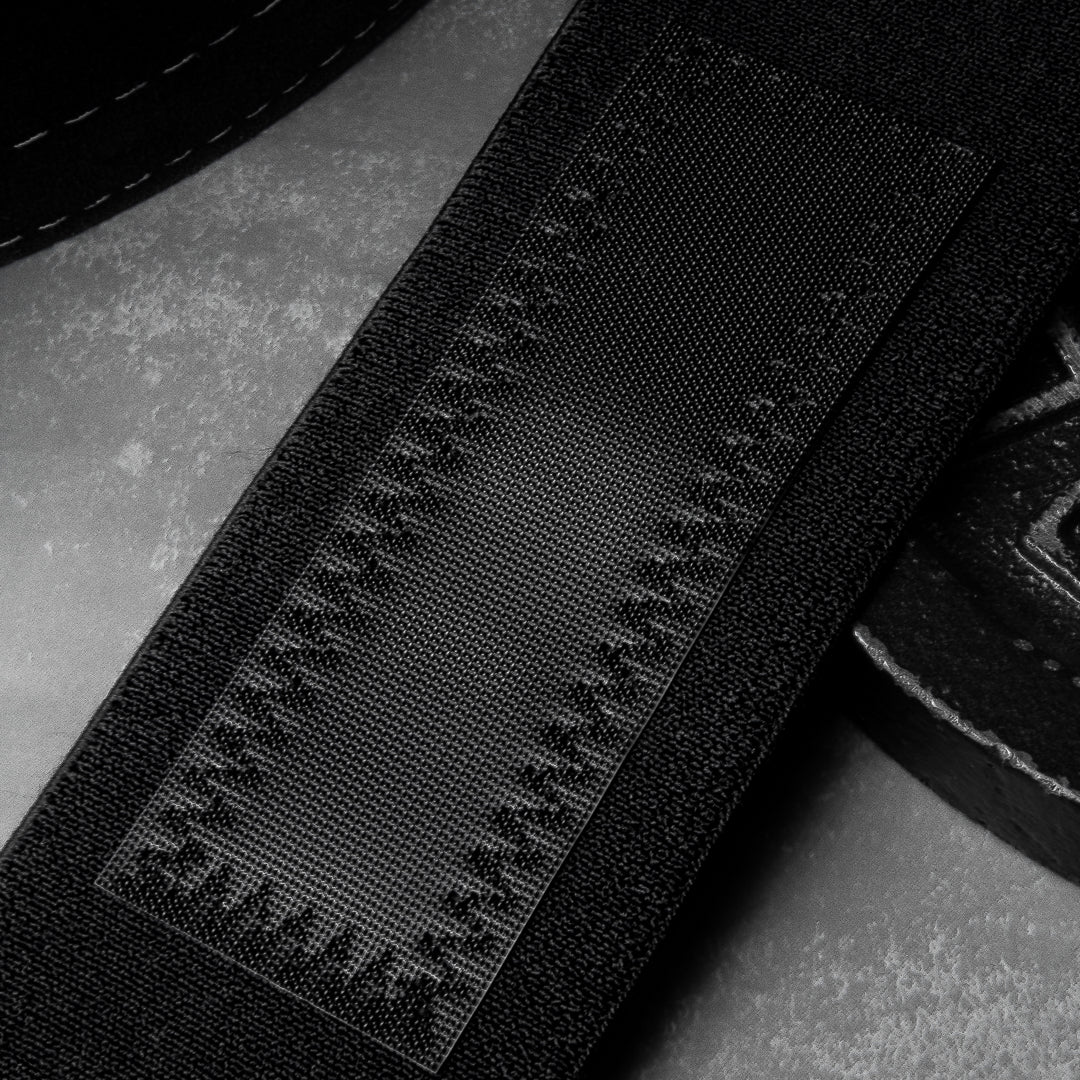 Powerlifting wrist wraps with reinforced 3.5mm nylon and double-row stitching for grip and support.
